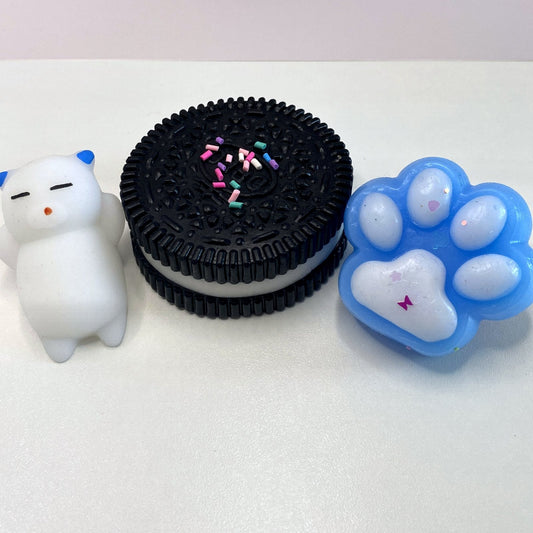 Pack 3 squishys CLADEA : cookie noir, patte de chat bleue et chaton blanc
